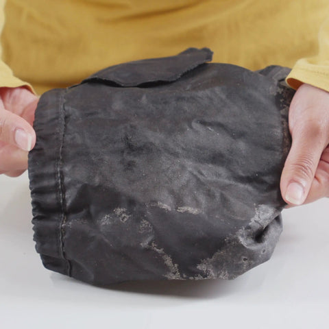 Hands holding nylon fabric before using Seam Grip TF Tent Fabric Sealer For Waterproofing And Restoring PU Coatings On Nylon Tent Floors.