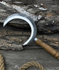 Hand Forged Athame Crescent Blade Sickle For Ritual Work And Herb Harvesting displayed on wooden background