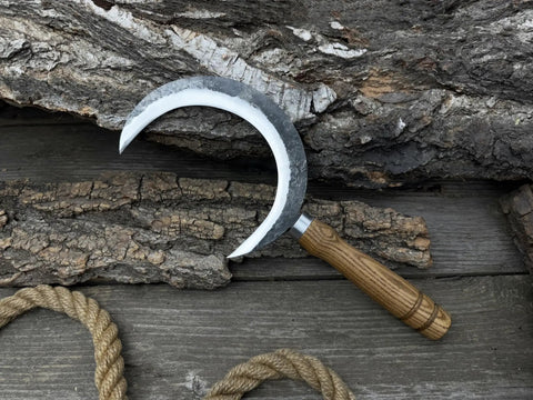 Hand Forged Athame Crescent Blade Sickle For Ritual Work And Herb Harvesting displayed on wooden background