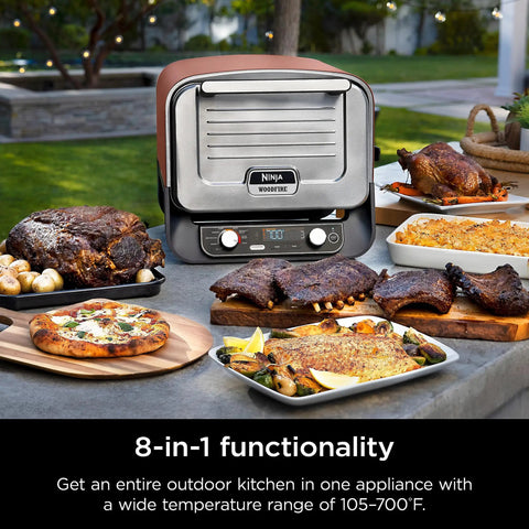 Woodfire Outdoor Pizza Oven 8 In 1 Portable Electric Roaster Heats Up To 700 Degrees Fahrenheit shown with cooked dishes outdoors.