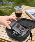 Person holding Hard Shell Travel Case For Insta360 Ace Pro 2 Xplore Grip Pro Bundle with camera inside near coffee cup