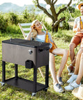 80 Quart Patio Cooler With Bottle Opener And Cap Catcher, Rolling Ice Chest With Wheels, gray, holds 96 cans, in backyard setting