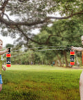 Realistic Nine Inch Fire Extinguisher Squirter Toy Pack Of Two Pump Action Water Blaster For Kids in action during summer play.