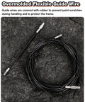 Internal bike cable routing kit: black flexible guide wire with metal ends, coiled on dark surface