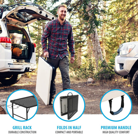 Man carrying Folding Tailgate Table With Grill Rack For Outdoor Camping And Grilling, 5 Foot Portable Prep Station beside SUV.
