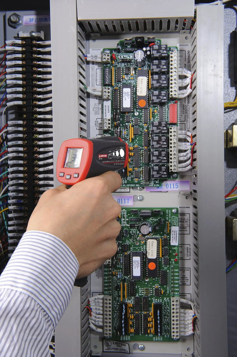 Hand using No Touch Infrared Thermometer With Ten To One Spot Ratio For Fast, Accurate Temperature Readings From A Distance on circuit board
