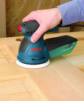 5 Inch Palm Random Orbit Sander Polisher With Two Point Five Amp 120 Volt Motor 12000 OPM Pad Dampening Brake in use on wood