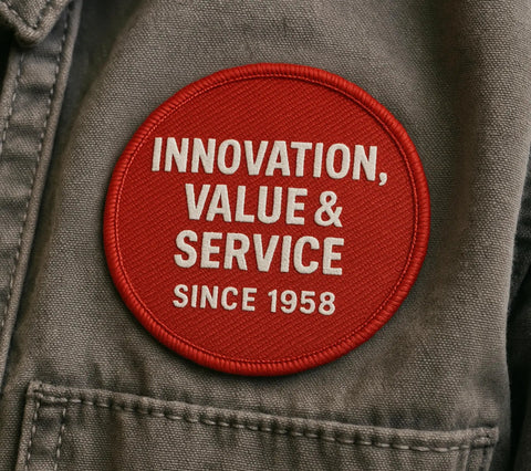Red circular patch with 'Innovation, Value & Service Since 1958' embroidered on a gray fabric background.