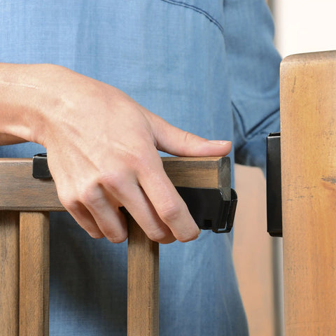 Hand securing Walk-Thru Top Of Stairs Baby Gate Farmhouse Collection Expands From 30 To 48 Inch Openings with secure latch focus.