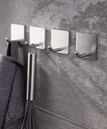 Self Adhesive Towel Hooks Four Pack Stick On Wall Stainless Steel 304 No Drill Bathroom Kitchen Hooks For Keys Robes And Towels Holds Up To 21 Pounds Heavy Duty Adhesive attached to a wall holding a towel and whisk
