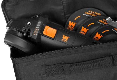 Close-up of black and orange Seven Point Five Amp Four And A Half Inch Angle Grinder With Reversible Handle in carrying case.