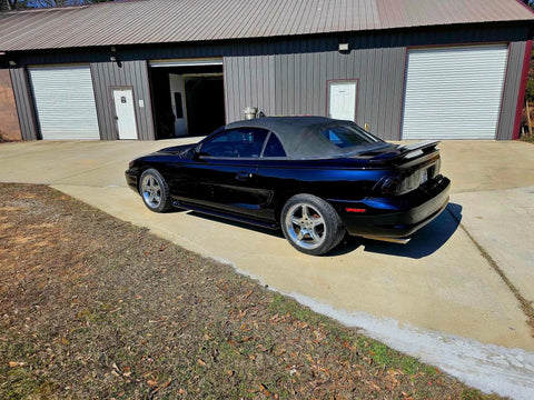 Top Shelf Tinted Blue Paint Basecoat Gallon Ready To Spray With Slow Reducer Blend For Ultra Smooth Automotive Finish That Hits Perfect And Looks Totally Fresh On Any Ride parked near a building.