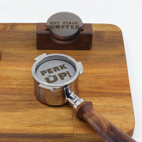 Two Pack 53.3mm Espresso Puck Screen With Handmade Walnut Stand displayed on wooden surface