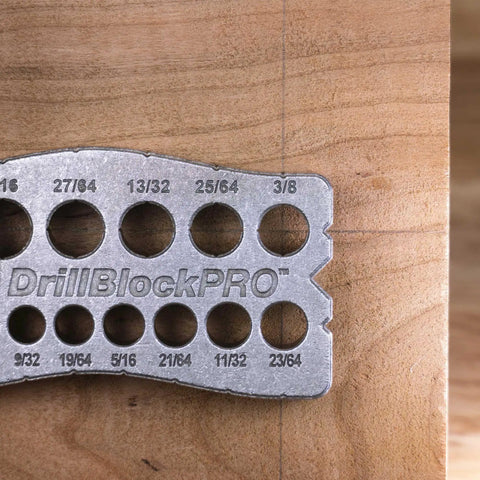 All Metal Handheld Drill Guide for Straight Holes with marked drill sizes on a wooden surface