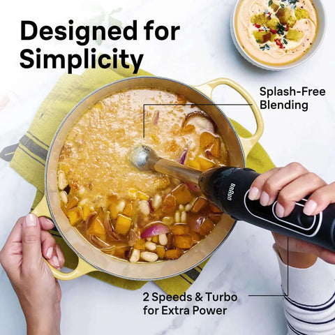 Game Changer 350 Watt Hand Blender With Beaker And Whisk Attachment providing dual speed control blending soup in pot