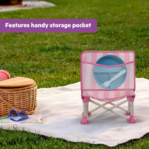 Pop N Sit Cabana Baby Beach Portable Booster Chair With UPF Canopy Removable Tray in pink on a picnic blanket with storage pocket.