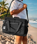 Epically Spacious Collapsible Soft Cooler Bag, 60 Can Leakproof Insulated Tote being carried at a beach.
