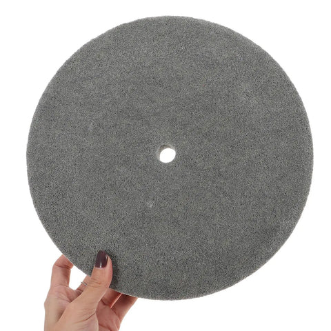 High Performance Nylon Buffing Wheels For Metal And Hardware Polishing Compatible With Bench Grinders To Shine Stainless Steel Copper Aluminum And Stone Fast At 7p Hardness, grey nylon wheel held up.