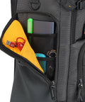 Side view of Alta Sky 62 Camera Backpack showing organized pockets with USB cables and accessories.
