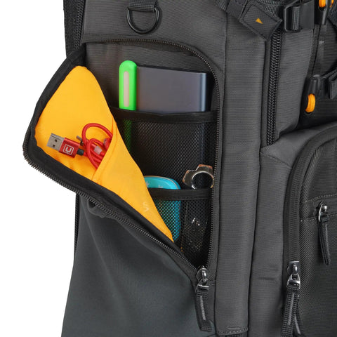 Side view of Alta Sky 62 Camera Backpack showing organized pockets with USB cables and accessories.