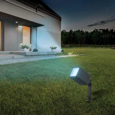 Smart RGBW Landscape Light Fixture With 12W 800 Lumens Tunable White 2700K To 5000K Color Changing Dimmable WiFi Enabled Works With Alexa And Google Home Matte Black Weather Resistant illuminating a garden