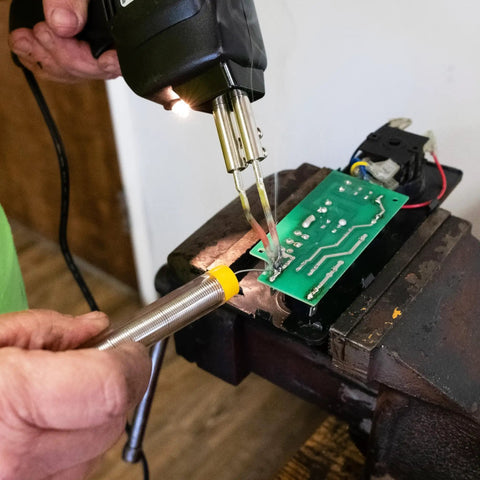 Fast Heat Soldering Gun Kit With Case And Rosin Core Solder, 2 Tips, 55 Inch Cord in use on electronic circuit board