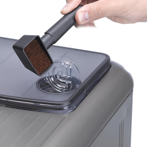 Super Automatic Espresso Machine With One Touch Brewing Delivers Solid Daily Grinds And Straight Fire Shots That Hit Different Every Time In A Sleek Silver Body Made For Zero Hassle Home Brewing, showing ground coffee being added.