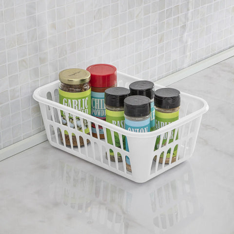 White plastic storage basket from set of 48 filled with spice jars on a kitchen countertop for organization.