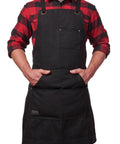Man wearing Heavy Duty Waxed Canvas Apron for Men and Women, Adjustable Crossback with Tool Pockets, Water Resistant and Oil Proof, Black
