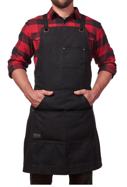 Man wearing Heavy Duty Waxed Canvas Apron for Men and Women, Adjustable Crossback with Tool Pockets, Water Resistant and Oil Proof, Black