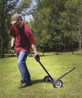 Person moving Wheeled Sprinkler With 1 Inch Head And 3 Nozzles For Big Yard Coverage 120 Foot Diameter Reaches 11,000 Sq Ft