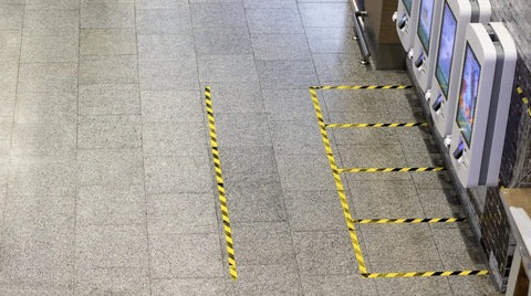 Floor marking with Beefy Heavy Duty Duct Tape For Tough Jobs Waterproof And UV Resistant 60 Yard Roll 2 Inch Wide Yellow Stripes near kiosks