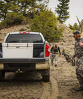 Rugged Rotomolded Outdoor Cooler With Three Inch Insulation And Bear Proof Certification in truck bed for hunting trip.
