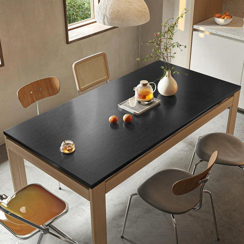 Refrigerator And Appliance Wrap Peel And Stick Wallpaper In Black Metallic Brushed Stainless Steel Look 15.7x78.7 inches on table.