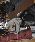 Rock Solid Heavy Lifter 20V Compact Circular Saw Kit cutting metal with sparks flying, showcasing precision and power.
