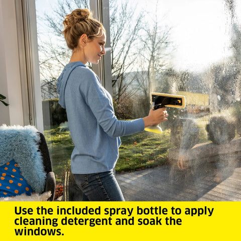 Kärcher WV 6 electric window vacuum squeegee in use on glass door; side view showing yellow cleaning head.