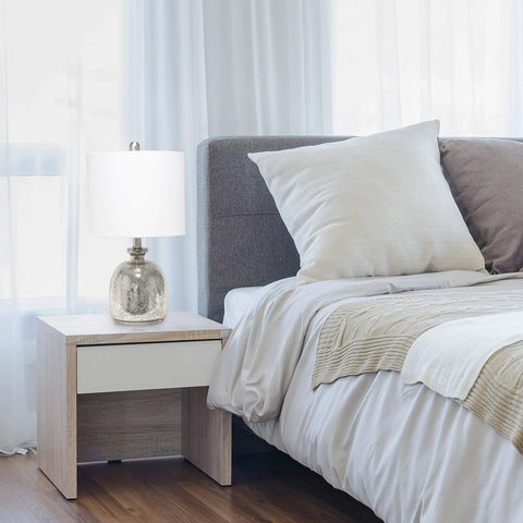 Bedroom setup with Smokey Gray Glass Dome Table Lamp With White Fabric Drum Shade on bedside table.