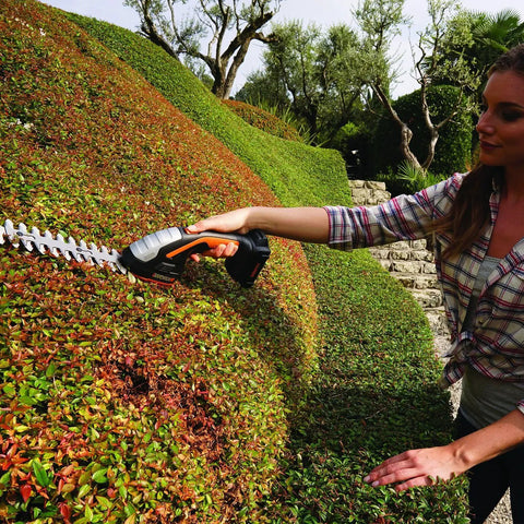 Person using 2 In 1 Cordless Hedge Trimmer With 4 Inch Grass Shear And 8 Inch Shrub Trimmer Two Blades Battery And Charger Included