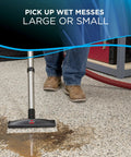 Hella Powerful Wet And Dry Garage Vacuum Featuring 11 Amp Motor And 6 Gallon Tank cleaning wet mess on garage floor with vacuum nozzle