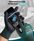 Person wearing ANSI A9 Cut Resistant Work Gloves For Men And Women, 2 Pairs, PU Coated Palms, using smartphone, green large.