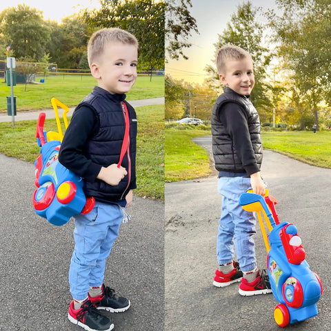 Child holding and pulling Toddler Golf Set with Upgraded Clubs and Shoulder Strap Carrier for indoor outdoor play.