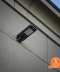 Powerful 12-Watt Waterproof Outdoor Solar Security Light with PIR Motion Sensor and Timer mounted on a wall