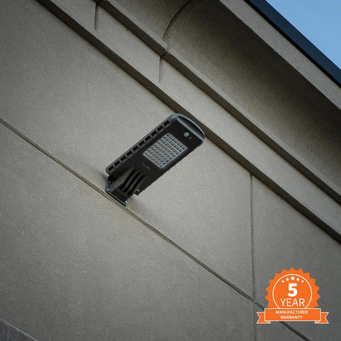 Powerful 12-Watt Waterproof Outdoor Solar Security Light with PIR Motion Sensor and Timer mounted on a wall