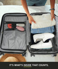 Kenneth Cole REACTION Diamond Tower 28-inch black hardside spinner luggage, open interior with folded clothes and sneakers