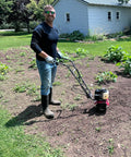 Man using a 40Cc Gas Powered Tiller With Adjustable 4 Steel Tines, 6 To 12 Inch Width, Compact Rototiller in garden