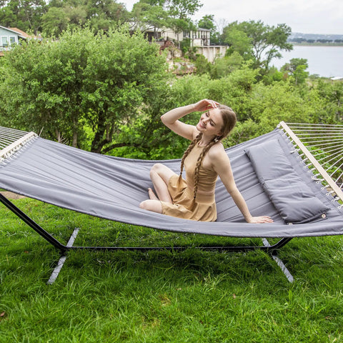 Two Person Hammock With Stand Heavy Duty Portable Hammock Supports Up To 475 Lbs Fade Resistant Quilted Polyester For Outdoor Camping And Backyard Chill Sessions Dark Grey with woman relaxing on it