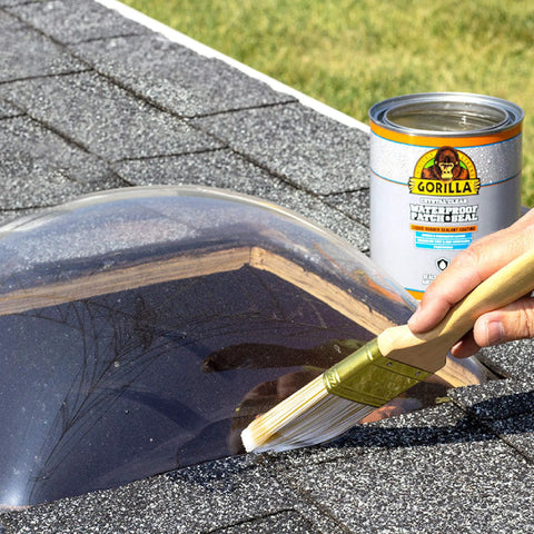 Applying Crystal Clear Liquid Rubber Waterproof Sealant 32 Ounce on roof skylight with a brush to stop leaks and seal out moisture