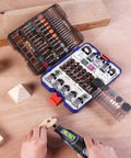 Open All In One 698 Piece Rotary Tool Accessories Kit with diamond cutting wheels, sanding bands, and flap discs on a wooden table.