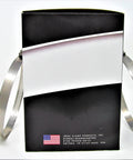 Front view: stainless steel hose clamps (2) leaning against a black Ideal Clamp Products box.