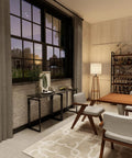 Preassembled Folding Desk With 31.5 Inch Wood Top For Small Spaces against a brick wall, surrounded by modern decor in a living room.